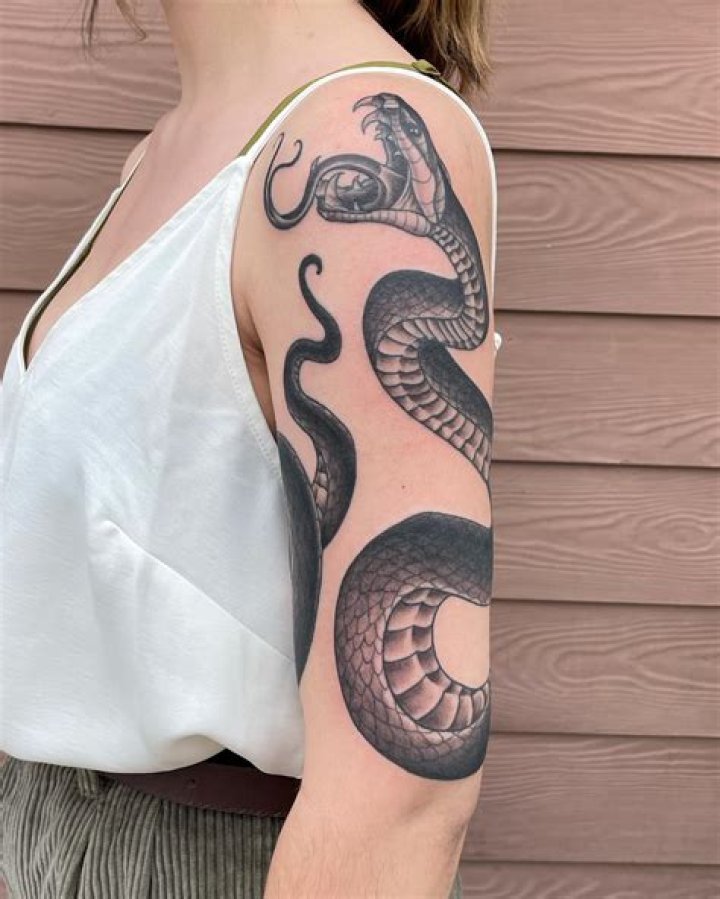 Unraveling the Allure of Snake Arm Tattoos Leading into the Shoulder